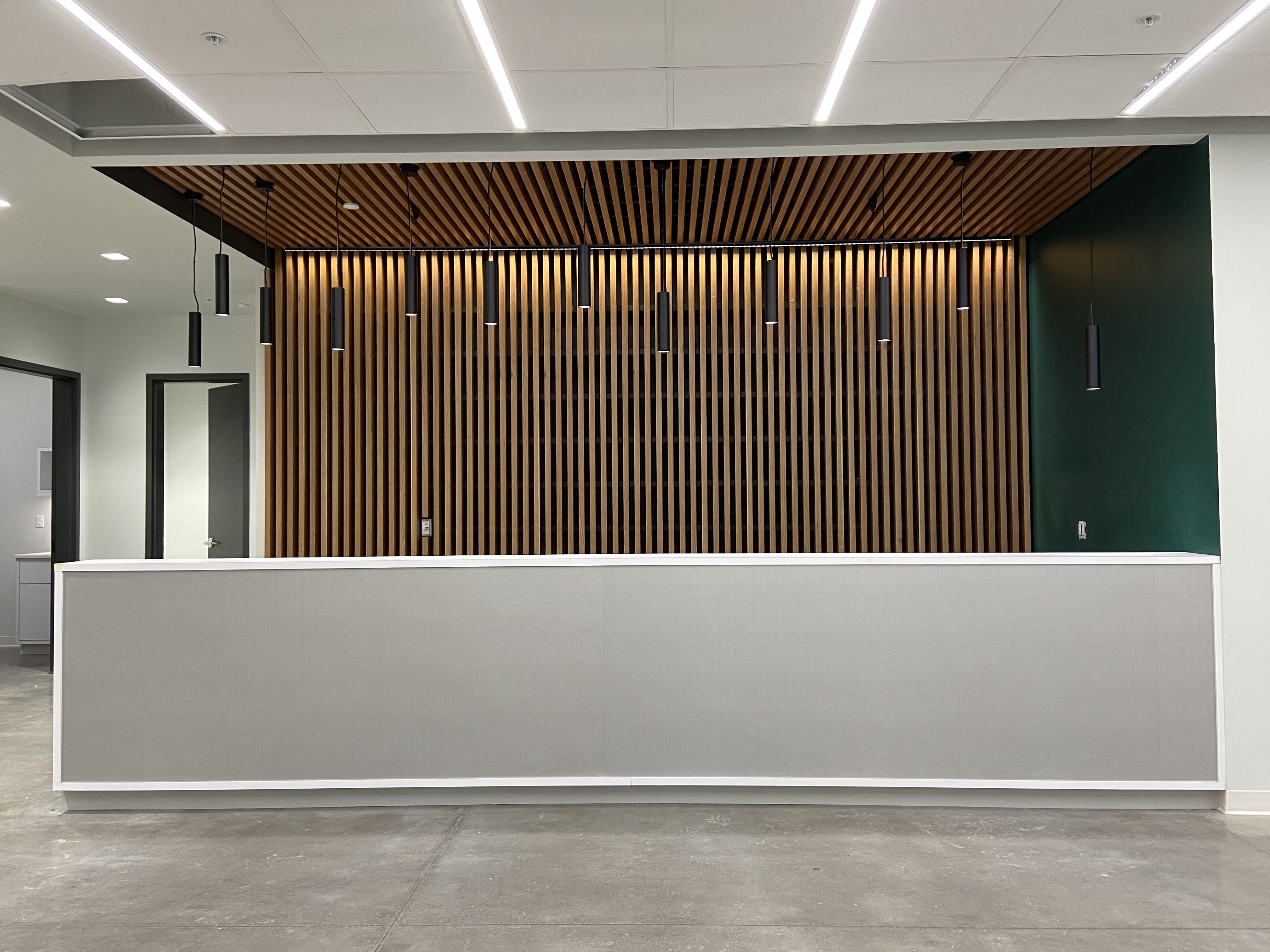 Custom reception desk with slatted wood feature wall
